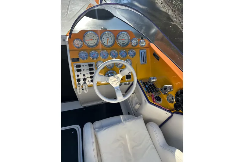 Slide: The Image of 2007 Eliminator Daytona 30 boat dashboard with gauges, steering wheel, and controls. - 22
