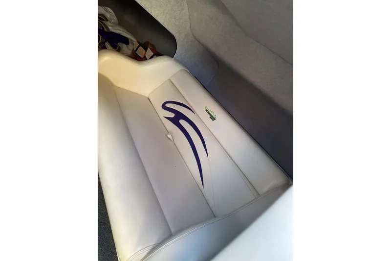 Slide: The Image of 2007 Eliminator Daytona 30 boat interior with white and blue seating design. - 24