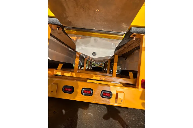 Slide: The Image of 2007 Eliminator Daytona 30 boat trailer underside with yellow frame and red lights. - 28