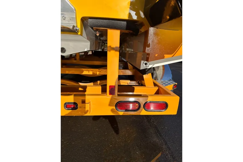 Slide: The Image of Rear view of a 2007 Eliminator Daytona 30 boat trailer with bright yellow finish. - 29