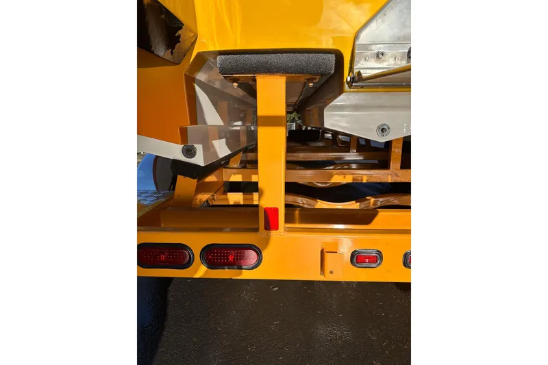 Slide: The Image of Rear view of a 2007 Eliminator Daytona 30 boat trailer with bright yellow finish. - 30