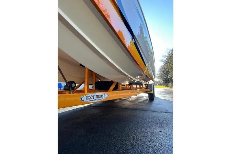 Slide: The Image of 2007 Eliminator Daytona 30 boat on orange Extreme custom trailer, side view. - 31