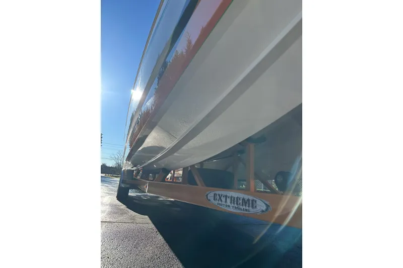 Slide: The Image of 2007 Eliminator Daytona 30 boat on Extreme custom trailer, sunlit side view. - 32