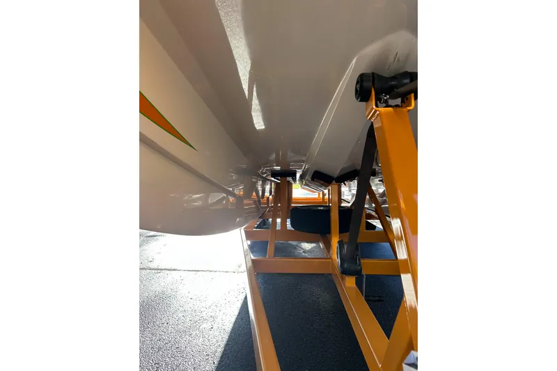 Slide: The Image of 2007 Eliminator Daytona 30 boat underside on orange trailer, showcasing sleek design. - 33