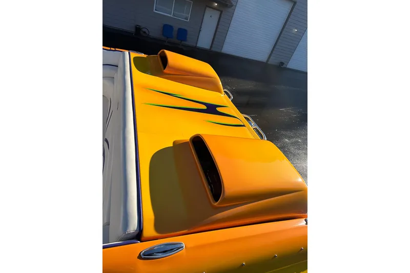 Slide: The Image of 2007 Eliminator Daytona 30 boat with vibrant yellow paint and sleek design. - 39