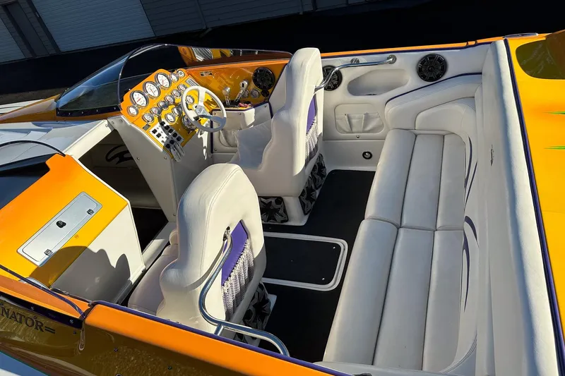 Slide: The Image of 2007 Eliminator Daytona 30 boat interior with white seating and vibrant orange dashboard. - 41
