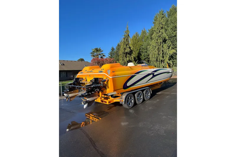 Slide: The Image of 2007 Eliminator Daytona 30 boat in vibrant orange with sleek design on a trailer. - 5