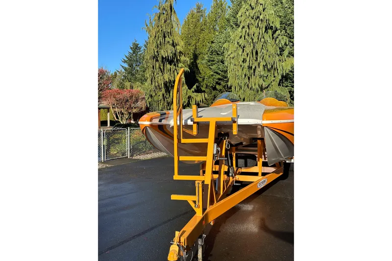 Slide: The Image of 2007 Eliminator Daytona 30 boat on trailer, surrounded by trees and clear blue sky. - 54