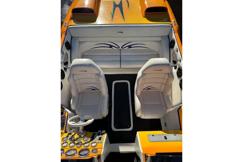 Slide: The Image of 2007 Eliminator Daytona 30 boat interior with white seats and orange accents. - 6