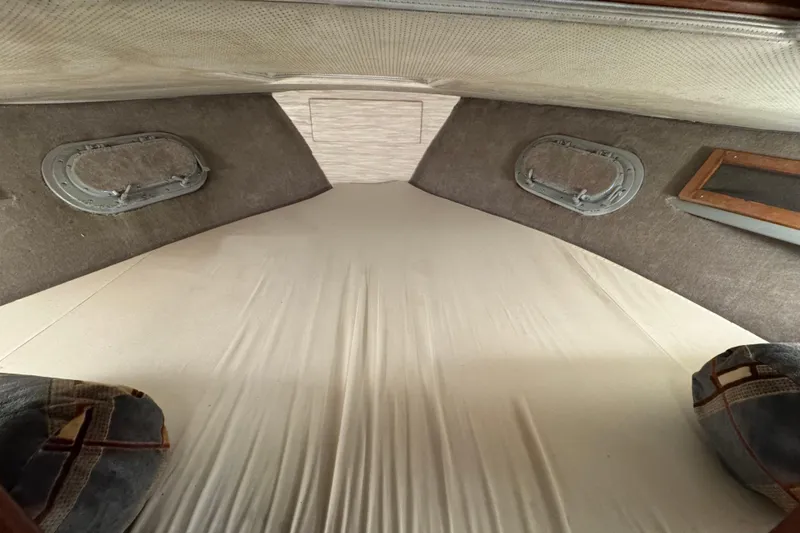 Slide: The Image of Interior cabin of a 1967 Pacemaker 37 boat with portholes and bedding. - 10