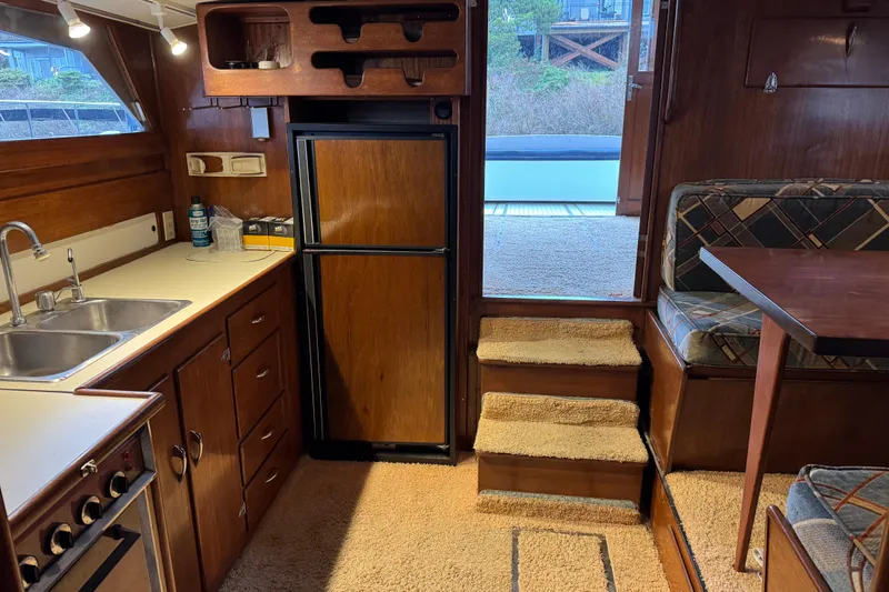 Slide: The Image of Interior of a 1967 Pacemaker 37 boat with kitchen and seating area. - 13