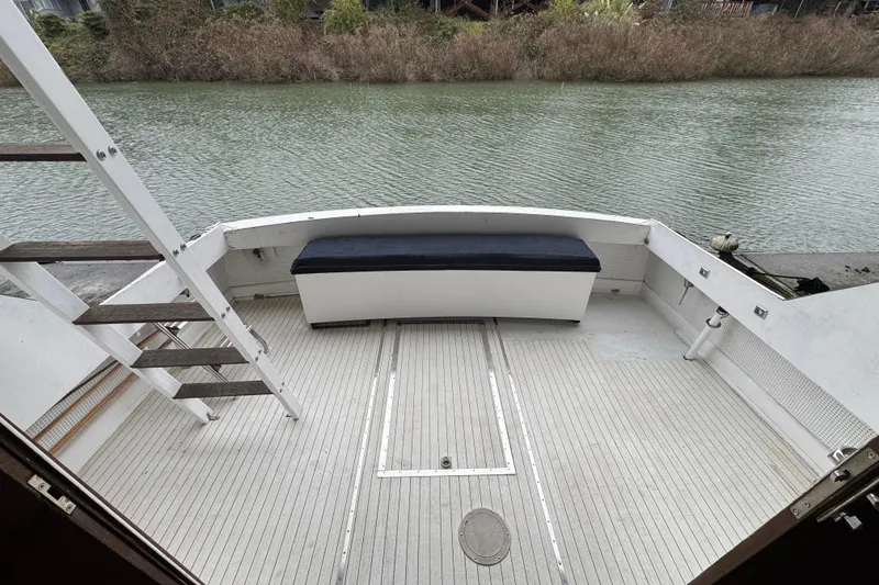 Slide: The Image of Rear deck of a 1967 Pacemaker 37 boat with seating and water view. - 14