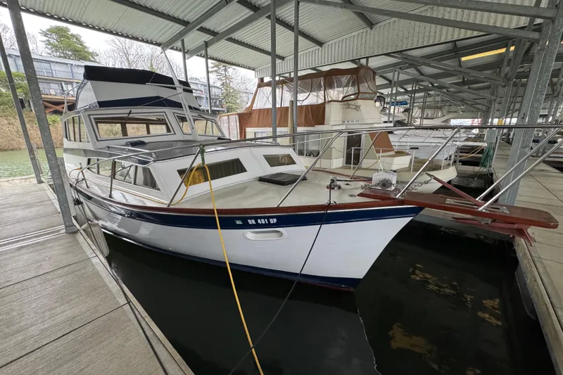 Slide: The Image of 1967 Pacemaker 37 boat docked in a covered marina, showcasing classic design. - 5
