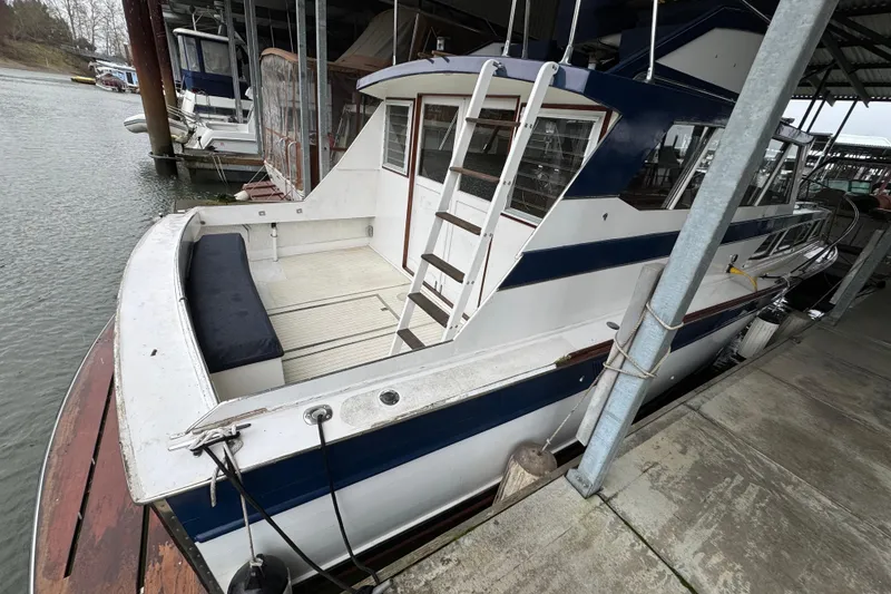 Slide: The Image of 1967 Pacemaker 37 boat docked in marina, featuring blue and white exterior. - 6