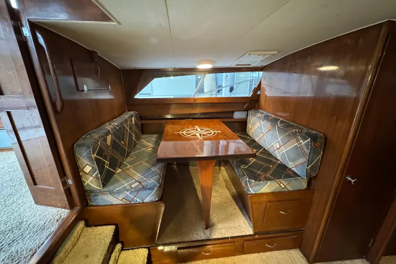 Slide: The Image of Cozy 1967 Pacemaker 37 boat interior with wood paneling and patterned seating. - 9