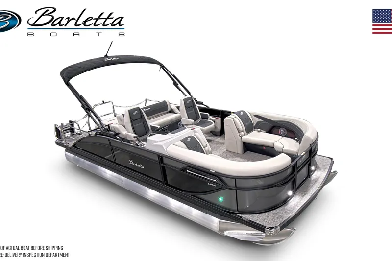 Slide: The Image of 2026 Barletta Cabrio 22UC pontoon boat in showroom, featuring sleek design and dual-axle trailer. - 3