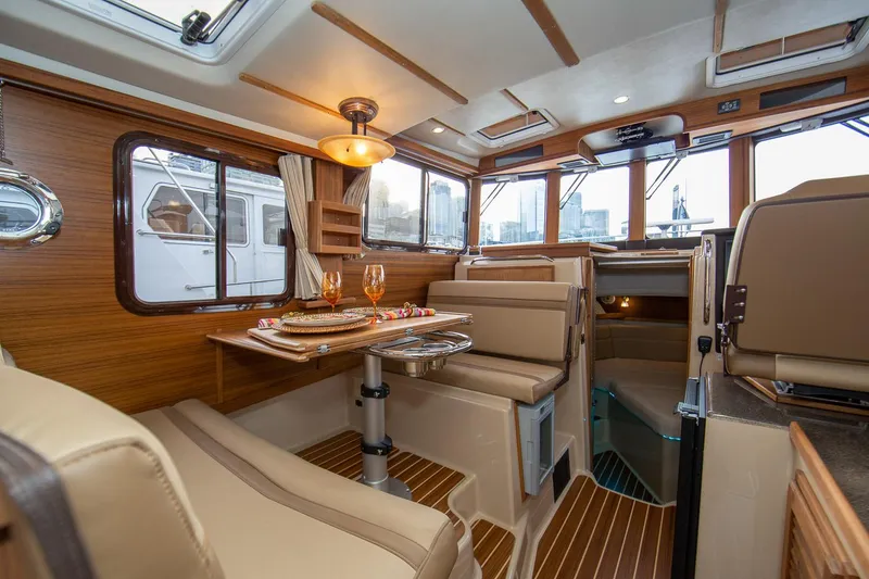 Slide: The Image of Manufacturer Provided Image: Luxurious interior of 2025 Ranger Tugs R-31 CB with elegant dining area. - 13