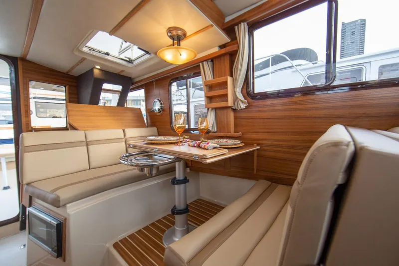 Slide: The Image of Manufacturer Provided Image: Luxurious interior of 2025 Ranger Tugs R-31 CB with elegant dining area. - 15