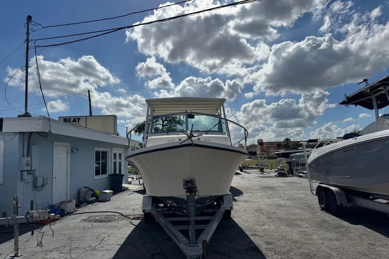 Slide: The Image of 2001 Parker 2110 Walkaround boat on trailer under cloudy sky. - 1