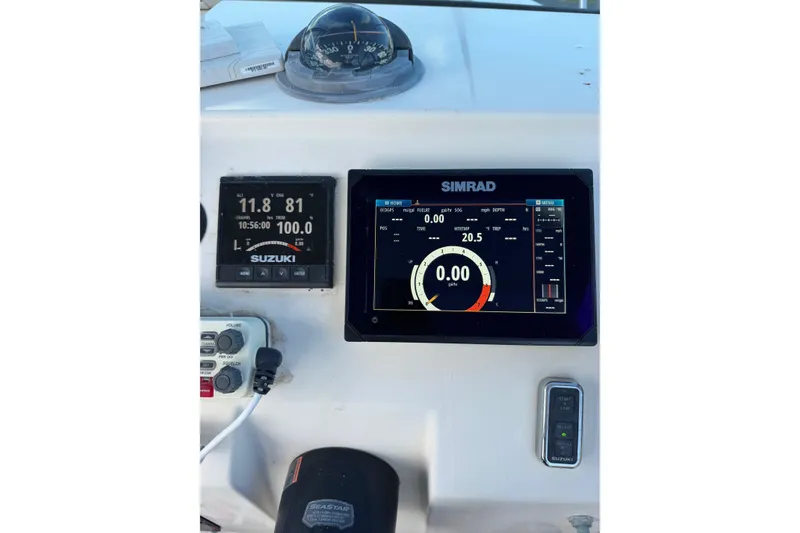 Slide: The Image of Dashboard of a 2001 Parker 2110 Walkaround boat with Simrad and Suzuki displays. - 10