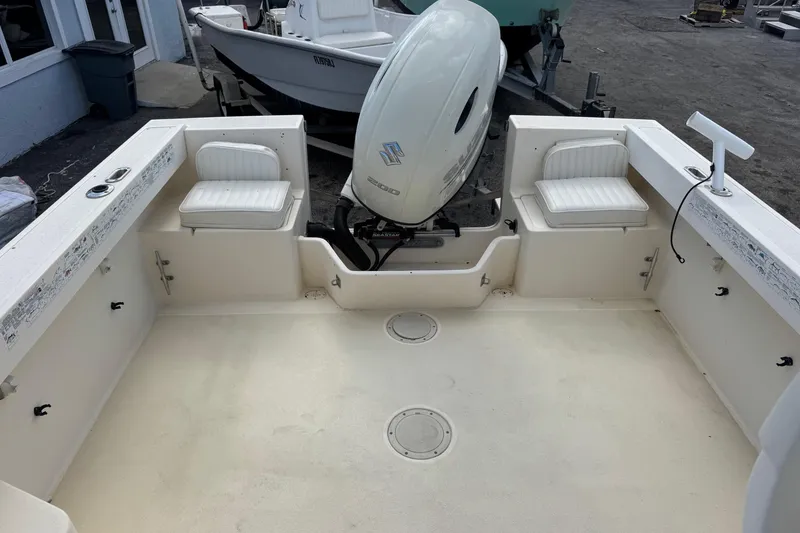 Slide: The Image of 2001 Parker 2110 Walkaround boat interior with seating and outboard motor. - 17