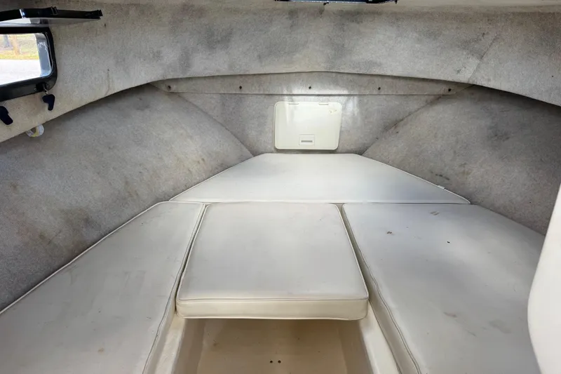 Slide: The Image of 2001 Parker 2110 Walkaround cabin interior with cushioned seating and small window. - 18