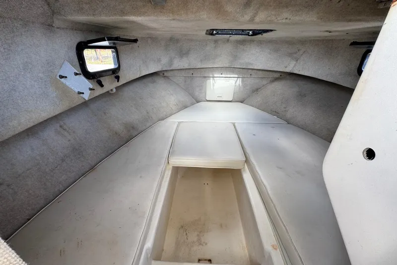 Slide: The Image of Interior cabin of a 2001 Parker 2110 Walkaround boat, featuring seating and storage. - 19