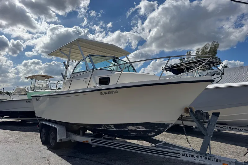 Slide: The Image of 2001 Parker 2110 Walkaround boat on trailer under cloudy sky. - 2