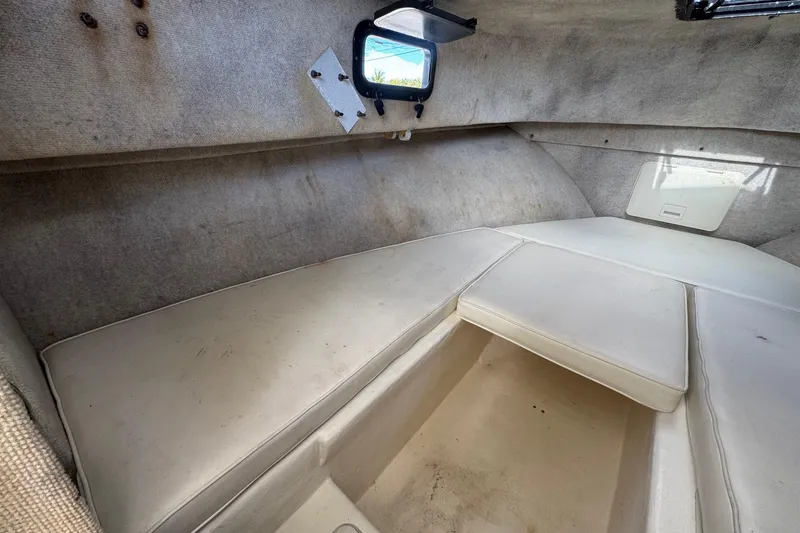 Slide: The Image of 2001 Parker 2110 Walkaround cabin interior with cushioned seating and small window. - 20