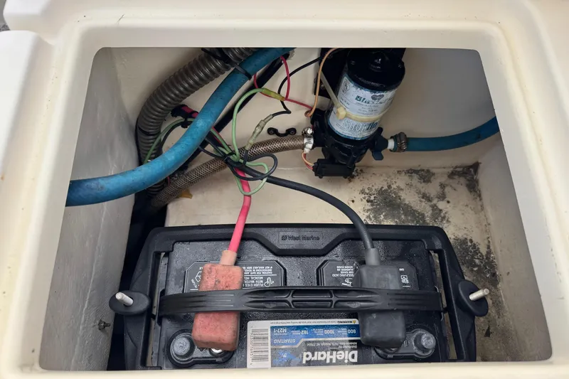 Slide: The Image of Battery compartment of a 2001 Parker 2110 Walkaround boat with wiring and pump. - 25