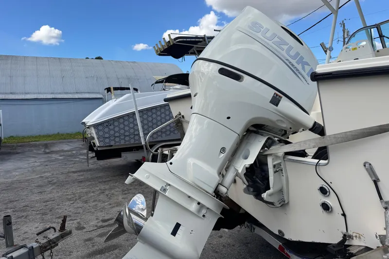 Slide: The Image of 2001 Parker 2110 Walkaround with Suzuki outboard motor in a boatyard. - 28