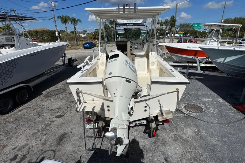 Slide: The Image of 2001 Parker 2110 Walkaround boat with Suzuki outboard motor, parked on a trailer. - 3