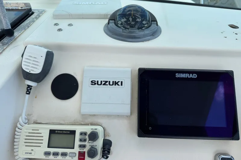 Slide: The Image of Control panel of a 2001 Parker 2110 Walkaround boat with Simrad and Suzuki equipment. - 9