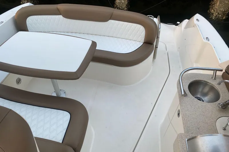 Slide: The Image of 2008 Sea Ray 310 Sundancer boat interior with seating, table, and sink. - 14