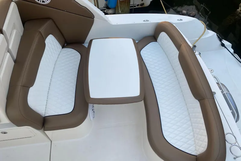 Slide: The Image of 2008 Sea Ray 310 Sundancer boat seating area with white and brown upholstery. - 16