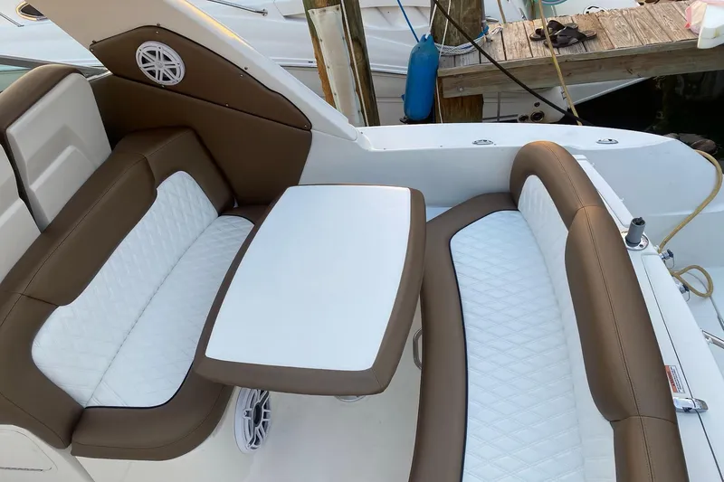 Slide: The Image of 2008 Sea Ray 310 Sundancer boat interior with brown and white seating and table. - 17
