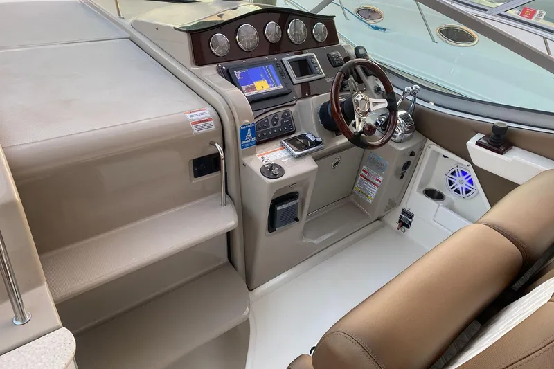 Slide: The Image of 2008 Sea Ray 310 Sundancer helm with modern controls and navigation system. - 19
