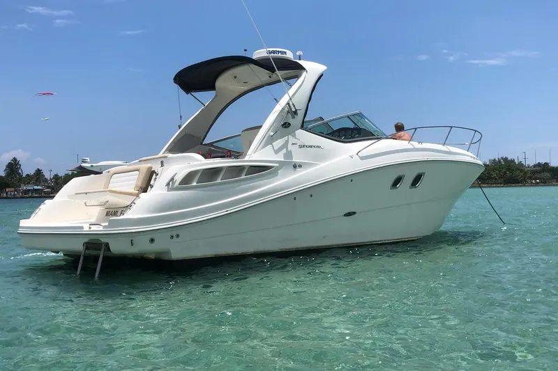 Slide: The Image of 2008 Sea Ray 310 Sundancer yacht anchored in clear turquoise waters. - 2