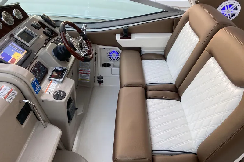Slide: The Image of 2008 Sea Ray 310 Sundancer helm with leather seating and advanced navigation controls. - 20
