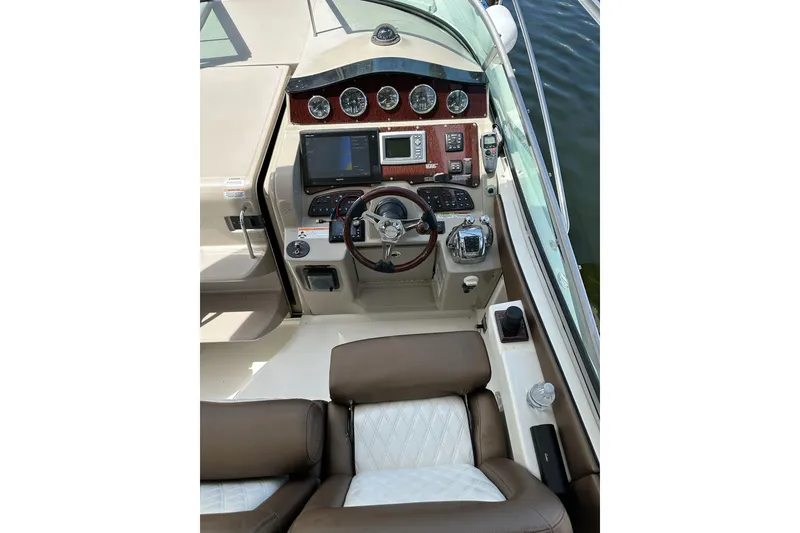 Slide: The Image of 2008 Sea Ray 310 Sundancer helm with modern controls and leather seating. - 22