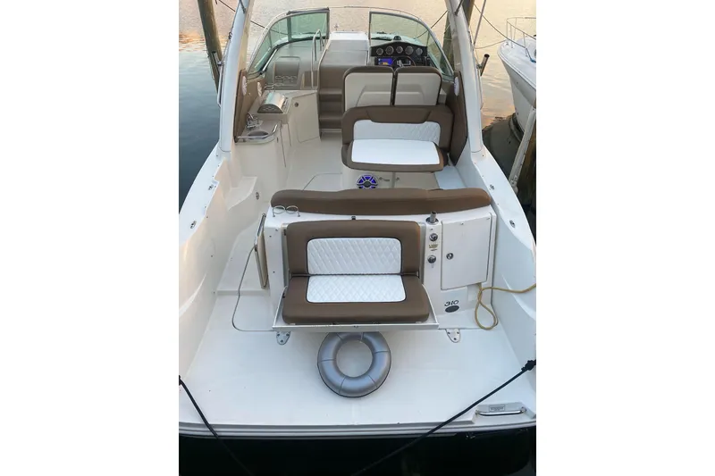 Slide: The Image of 2008 Sea Ray 310 Sundancer boat interior with cushioned seating and control panel. - 23
