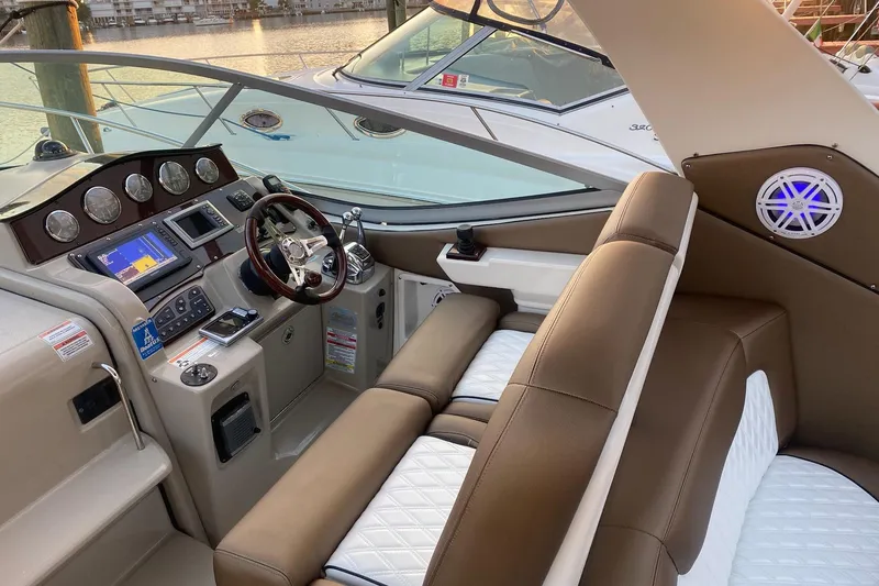 Slide: The Image of 2008 Sea Ray 310 Sundancer cockpit with modern controls and luxurious seating. - 26