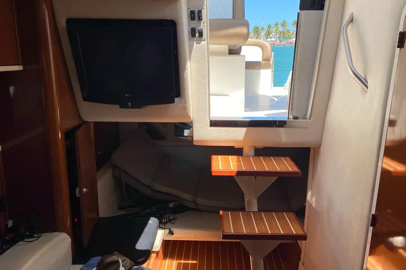 Slide: The Image of Interior view of 2008 Sea Ray 310 Sundancer yacht with steps and TV. - 29