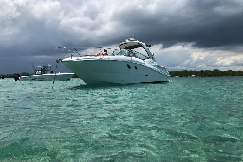 Slide: The Image of 2008 Sea Ray 310 Sundancer yacht on turquoise water under cloudy skies. - 7