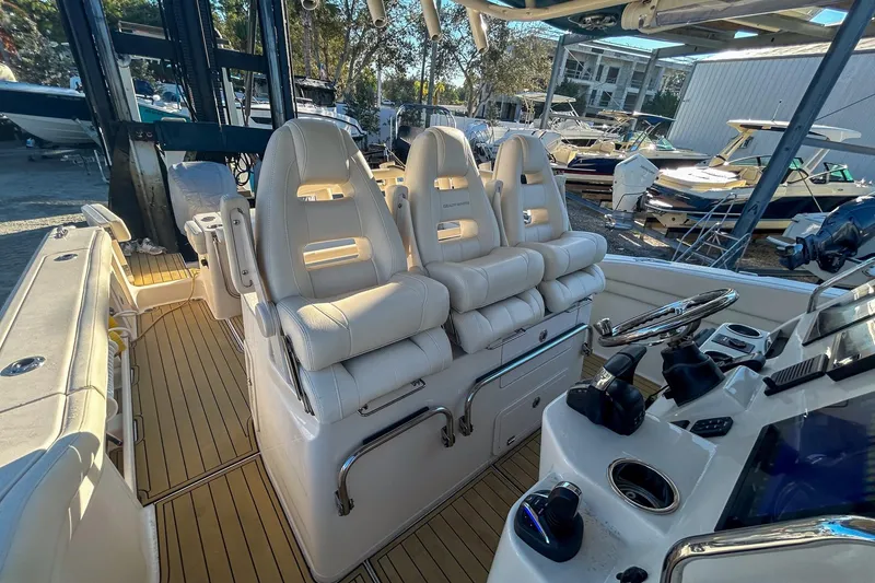 Slide: The Image of 2021 Grady-White Freedom 325 boat interior with luxurious seating and modern controls. - 11