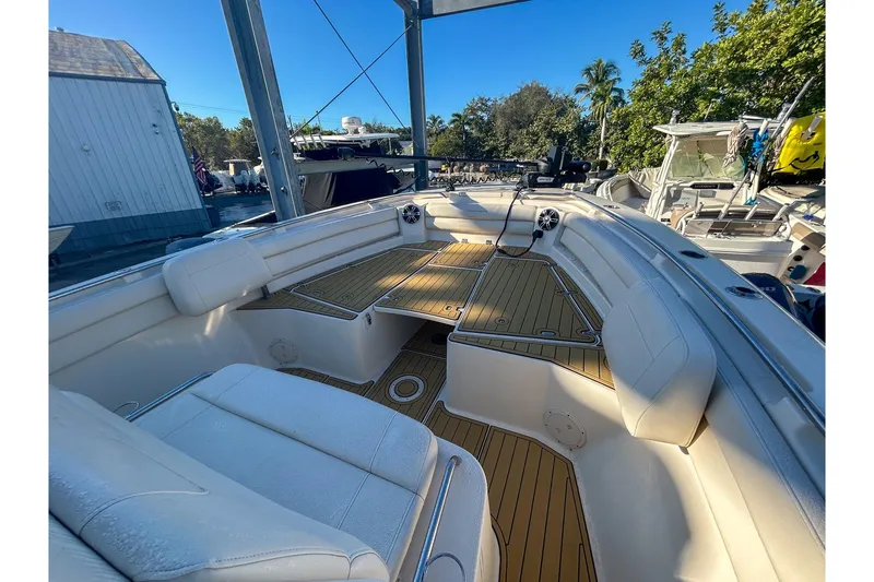 Slide: The Image of 2021 Grady-White Freedom 325 boat interior with white seating and wooden deck. - 12