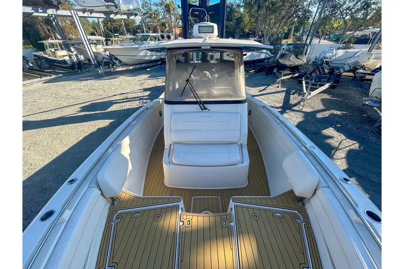 Slide: The Image of 2021 Grady-White Freedom 325 boat interior with seating and teak flooring. - 13