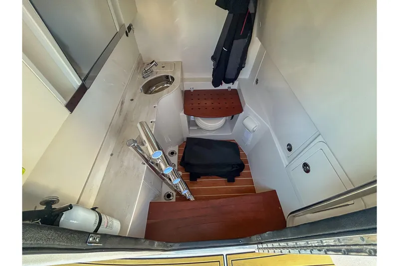 Slide: The Image of 2021 Grady-White Freedom 325 boat interior with sink, toilet, and wooden flooring. - 14
