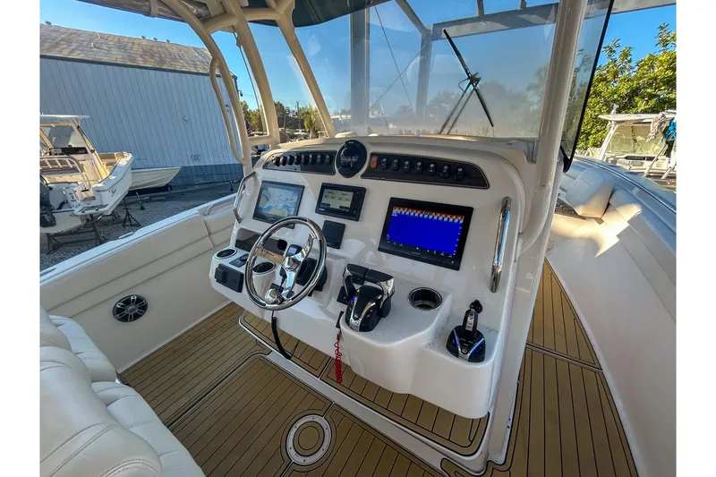 Slide: The Image of 2021 Grady-White Freedom 325 boat dashboard with modern navigation controls and steering wheel. - 15