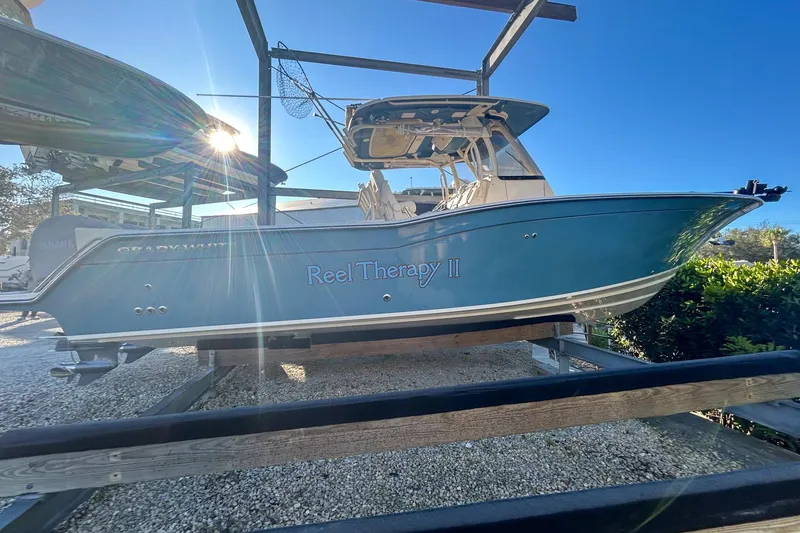 Slide: The Image of 2021 Grady-White Freedom 325 boat named "Reel Therapy II" on display in sunlight. - 2